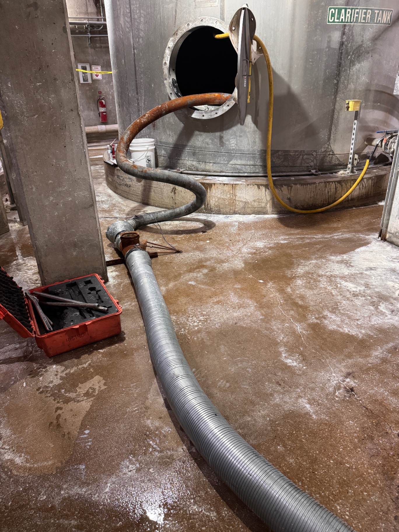 Vacuum truck tank cleanout with water hoses